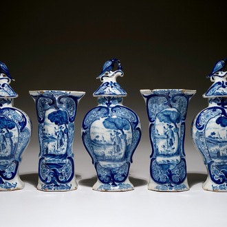 A Dutch Delft blue and white five-piece garniture with a hunter, 19th C.