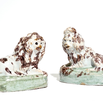 A pair of polychrome Brussels faience models of dogs, 18th C.