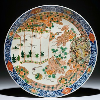Un grand plat en porcelaine de Japon d'Arita aux êtres mythiques, 19ème