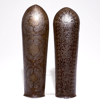 Two engraved and damascened Qajar bazuband arm guards, Iran, 18/19th C.