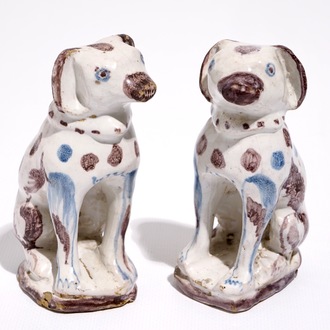 A pair of blue and manganese Brussels faience models of dogs, 18th C.