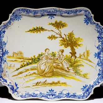 A polychrome Dutch Delft serving tray with a romantic scene, 18th C.