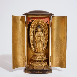 A Japanese lacquered and gilt wood "Zushi" shrine with a standing Buddha on a lotus throne, Edo, 17/18th C.