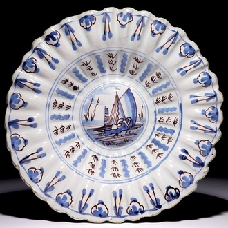 A Dutch Delft blue and manganese lobed dish with a boat, 17/18th C.