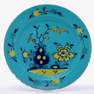 A rare polychrome Dutch Delft turquoise ground plate, 18th C.