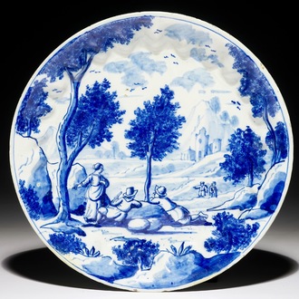 Een fijn blauw-wit Delfts bord met reizigers in een landschap, begin 18e eeuw
