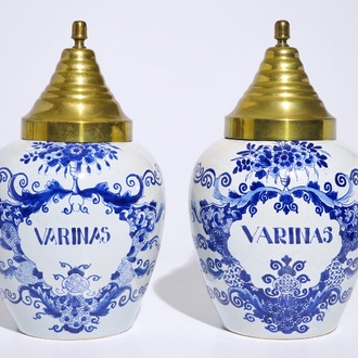 A pair of Dutch Delft blue and white tobacco jars with brass covers, 19th C.