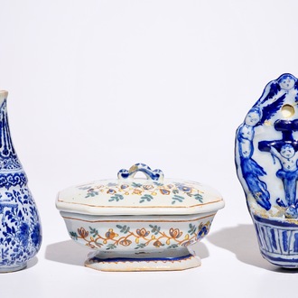 A Dutch Delft blue and white holy water font and a vase, with a polychrome covered spice box, 18th C.