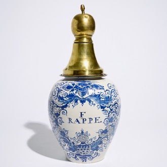 A Dutch Delft blue and white tobacco jar with brass cover, 18th C.