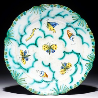A Brussels faience plate with butterflies and caterpillars, 18/19th C.