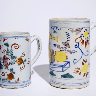 Two polychrome Dutch Delft mugs with birds, vases and flowers, 18th C.