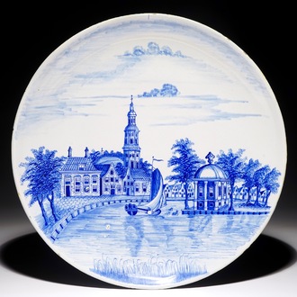 A Dutch Delft blue and white dish with a fine landscape scene, early 19th C.