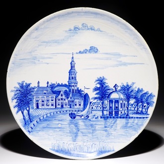 A Dutch Delft blue and white dish with a fine landscape scene, early 19th C.