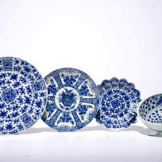 Three Dutch Delft blue and white plates and a two-eared porringer, 17/18th C.