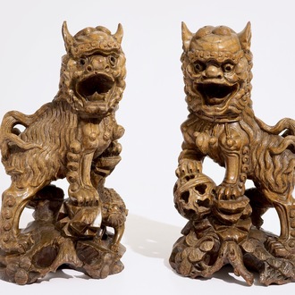A pair of Chinese carved wood figures of temple lions, 19/20th C.