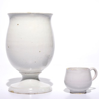 A white Dutch Delft drug jar on foot and a cup with ear, 18th C.