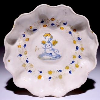 An Italian maiolica crespina with a putto, Faenza, early 17th C.