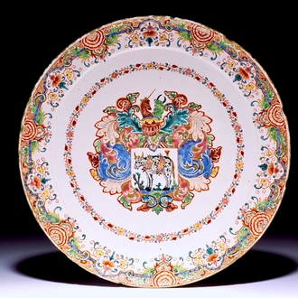 A Dutch Delft polychrome petit feu armorial plate with a prize-winning cow, 18th C.