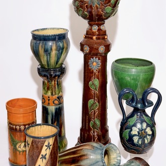 A large collection of Flemish pottery, mostly jardinieres on stands, early 20th C.