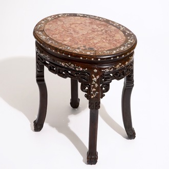 An oval Chinese marble-top mother of pearl inlaid sculpted wood stand, 19th C.