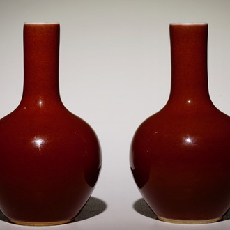 A pair of small Chinese monochrome copper red tianqiu ping bottle vases, 19/20th C.