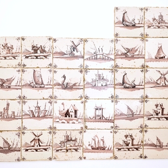 A set of 26 manganese Dutch Delft landscape tiles, 18/19th C.