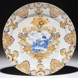 A fine polychrome Dutch Delft dish with a fluvial landscape, 18th C.