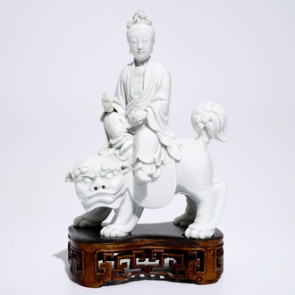 A Chinese Dehua blanc de Chine model of Guanyin seated on a Buddhist lion, 19th C.