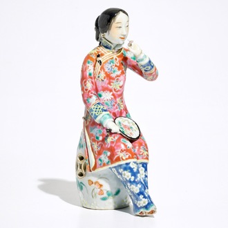 A Chinese famille rose model of a lady on a garden seat, 19th C.