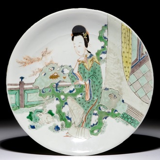 A Chinese famille verte plate with a lady in the garden, Kangxi mark and period