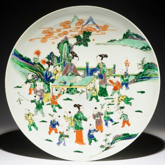 A very large Chinese famille verte dish with ladies and playing boys in a garden, 19th C.