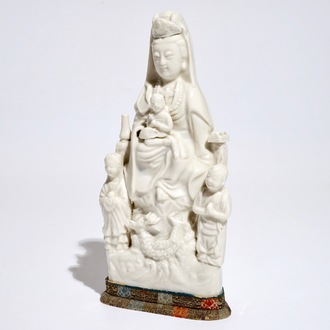 A Chinese Dehua blanc de Chine model of Guanyin with a child and acolytes, Kangxi