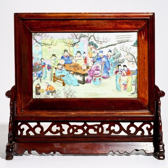 A Chinese wooden table screen with a famille rose plaque, 20th C.