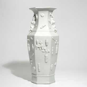 A hexagonal Chinese monochrome white vase with applied design, 19th C.
