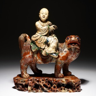 A Chinese soapstone figure of the immortal Vajraputra on a Buddhist lion, Kangxi/Qianlong