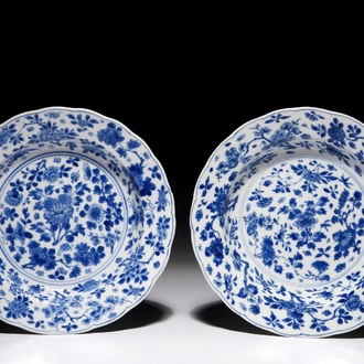 A pair of Chinese blue and white plates with floral design, Kangxi mark and of the period