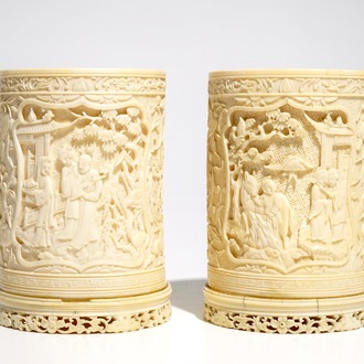 A pair of Chinese ivory brushpots with figural design, 19th C.