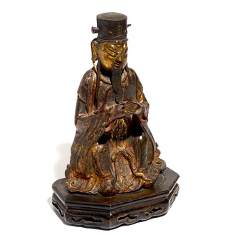 Een Chinese deels vergulde en polychrome bronzen figuur van Wenchang Dijun op houten sokkel, Ming