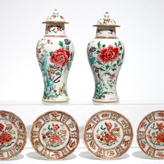 A pair of Chinese famille rose covered vases and four saucers, Yongzheng/Qianlong