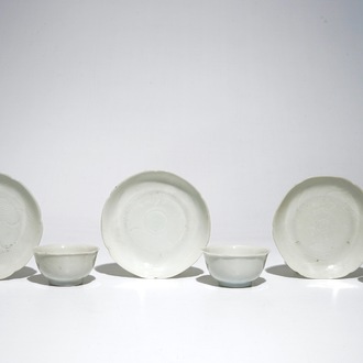 Three blanc de Chine cups and saucers with floral anhua design, Yongzheng/Qianlong