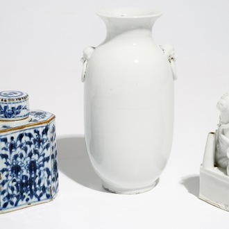 A Chinese Dehua blanc de Chine temple lion, a vase and a blue and white tea caddy, Kangxi and later