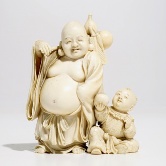 A Chinese ivory group of Buddha with a boy, signed, late 19th C.