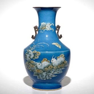 Un vase en porcelaine de Chine à décor de lapins et papillons sur fond bleu, 19ème