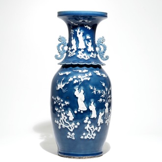 A tall Chinese blue-ground vase with applied white design, 19th C.