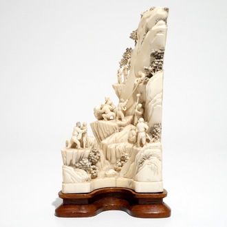 A Chinese ivory group of miners on a rock, 2nd quarter 20th C.