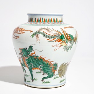 A Chinese wucai baluster vase with a kylin and a phoenix, 19th C.