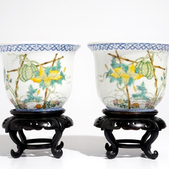 A pair of small Chinese famille rose jardinieres on wooden stands, early 20th C.