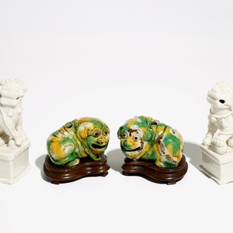 A pair of Chinese Dehua blanc de Chine Buddhist lion joss stick holders and a pair of verte biscuit dogs, Kangxi