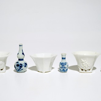 Three Chinese blanc de Chine libation cups and three blue and white miniature vases, Kangxi