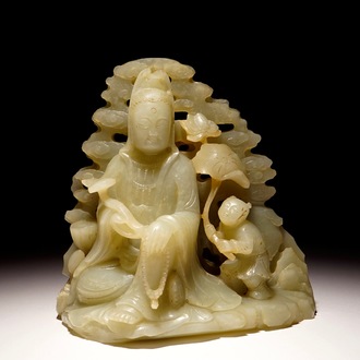 Een Chinese lichte celadon jade groep van Guanyin met een jongen, 19/20e eeuw